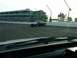 1993 Ford Mustang - A dark sedan, likely a police vehicle, drives on a race track with a grandstand in the background.