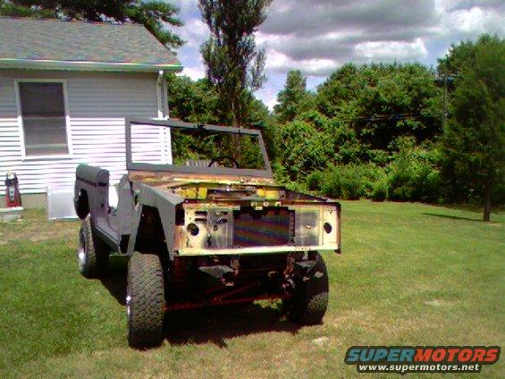 Ford Bronco body with no front clip or fenders, sitting in a grassy yard