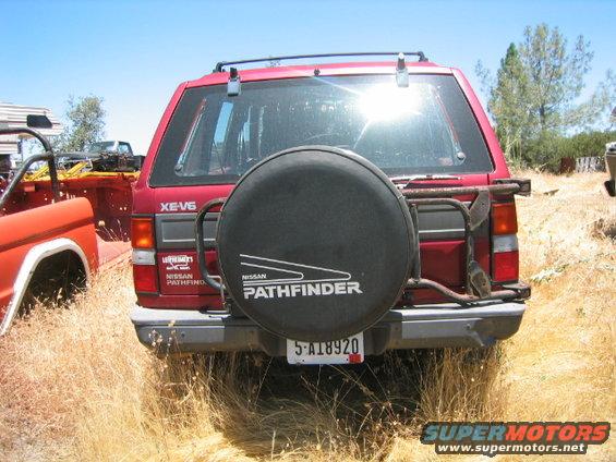 Red Nissan Pathfinder rear view with spare tire and license plate 5-A18920