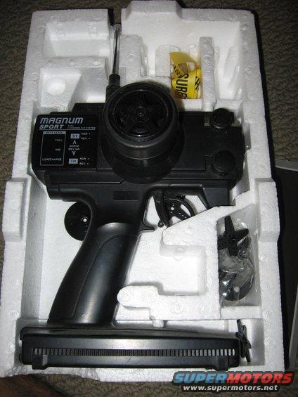 Black Magnum Sport radio control transmitter with steering wheel and trigger, in white foam packaging