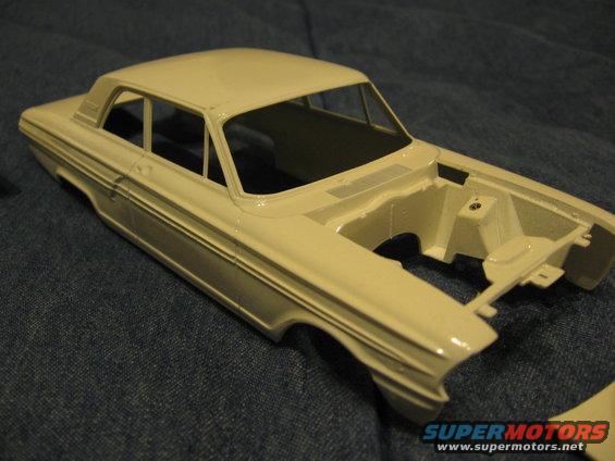 Unpainted plastic model car, 3/4 front view, cream color