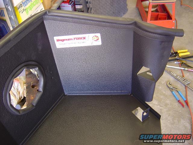 Black air intake box with a red and white 'Magnum FORCE' sticker. Tools are visible in the background