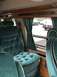 1992 Ford E150 - Interior view of a van's captain's chairs, with other vehicles visible through the window.