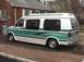 1992 Ford E150 - Side view of a 1992 Ford E150 conversion van with custom paint and window tint.