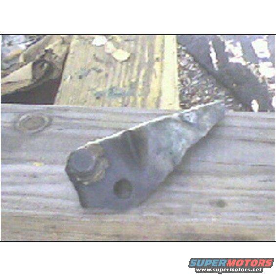 Metal part with bolt hole on weathered wood