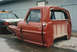 1967 Ford F-100 - A damaged red 1967 Ford F-100 truck cab and front clip sits beside a state trooper vehicle.