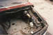 1967 Ford F-100 - The engine bay of a 1967 Ford F-100 shows the brake booster and master cylinder, with wiring and hoses exposed.