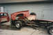 1967 Ford F-100 - Two heavily damaged red pickup trucks sit in a yard, one appearing to be a chassis and the other a cab.