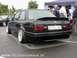 1989 BMW 3 Series - Rear view of a modified black 1989 BMW 325i, custom wheels and a spoiler, parked outdoors.
