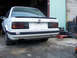 1989 BMW 3 Series - Rear view of a white 1989 BMW 3 Series sedan with a spoiler and 325is badging.