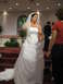 1988 Ford Bronco - A bride stands on a red carpeted stage, holding a bouquet and speaking with another woman.