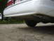 1997 Ford Crown Victoria - Rear view of a white 1997 Ford Crown Victoria, showing the bumper, exhaust, and a portion of the tire.