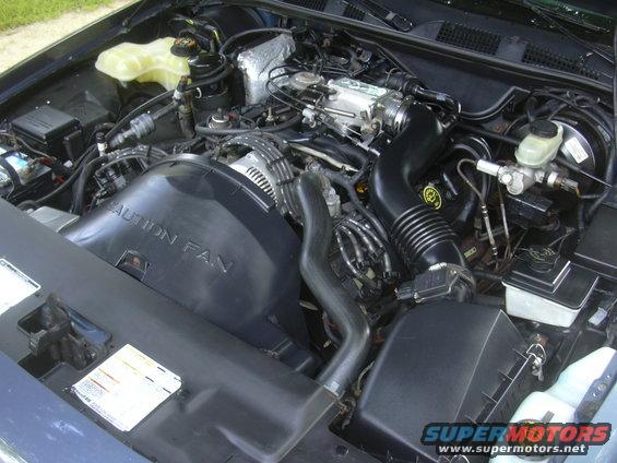 Engine bay with 'CAUTION FAN' visible on fan shroud