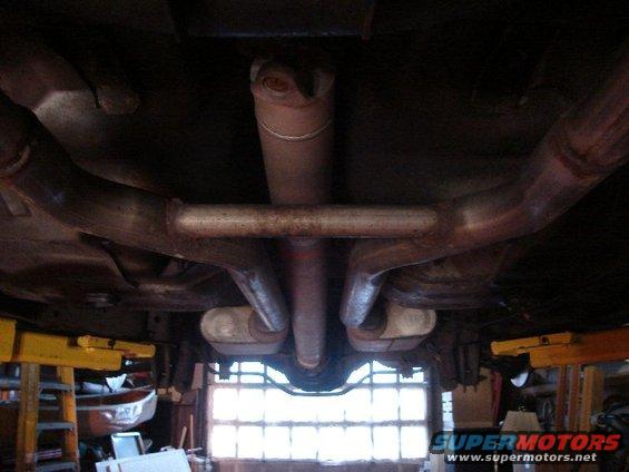 Undercarriage view of dual exhaust pipes and driveshaft