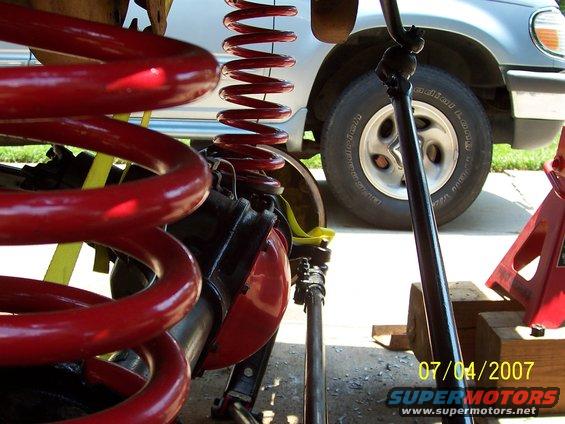 Close-up of red suspension springs and a silver SUV tire with "BFGoodrich Radial Long Trail" text. Date stamp "07/04/2007" visible