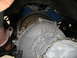 1973 Ford Ranchero - Close-up view of a transmission bell housing and flywheel, with a blue engine block in the background.