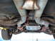 1973 Ford Ranchero - The underside of a vehicle reveals its exhaust system and transmission components.