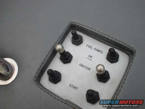 Interior switch panel with labels for FUEL PUMPS, ON, IGNITION, and START. Six toggle switches are visible