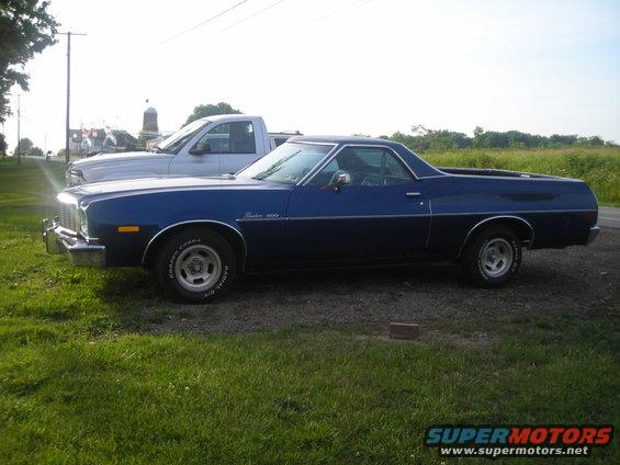 1975 Ford Ranchero parked next to a silver pickup truck