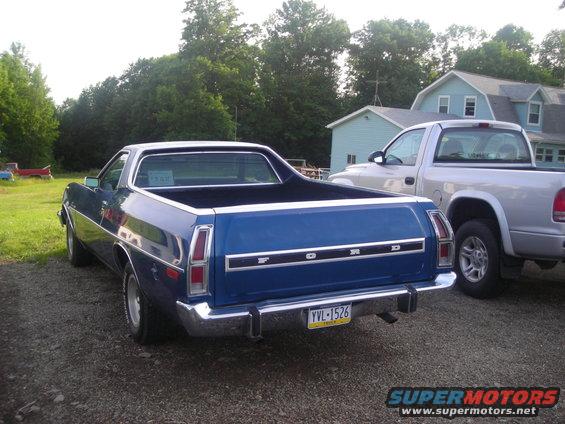 Blue Ford Ranchero pickup truck parked next to a silver pickup truck