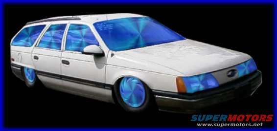 White station wagon with blue tinted windows and custom wheels, viewed from the front three-quarter angle