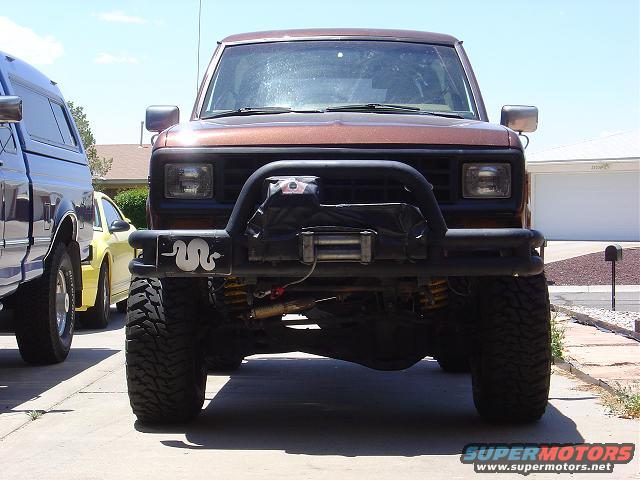 Front view of a brown 1986 Ford Bronco II with winch and brush guard