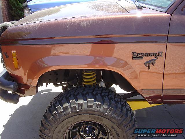 Brown Ford Bronco II fender with "BroncoII" badge and large off-road tire