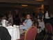 1988 Ford Bronco - A man holds a baby while seated at a banquet table during a formal event.