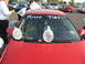 1988 Ford Bronco - A red car is decorated with condoms and text on the windshield, possibly for a wedding celebration.