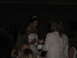 1988 Ford Bronco - A bride wearing a tiara and necklace interacts with guests during a wedding reception.