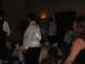 1988 Ford Bronco - A wedding reception scene with guests in formal attire gathered around tables in a dimly lit room.