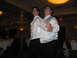 1988 Ford Bronco - Two men in white shirts and vests dance at a formal event, possibly a wedding reception.