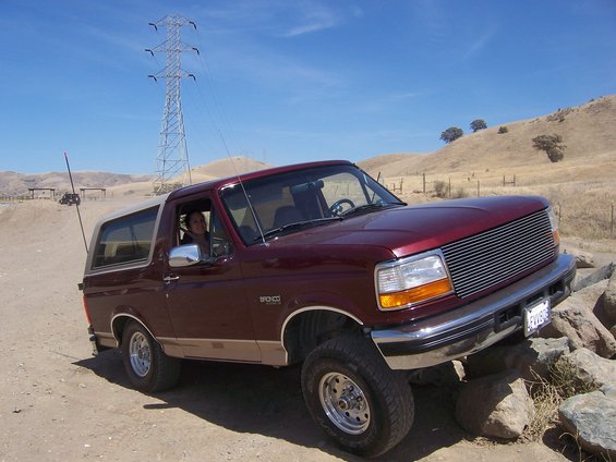 Red 1992 Ford Bronco on rocky terrain