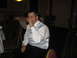 1988 Ford Bronco - A man in formal attire sips a drink while seated at a table during an event.