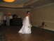 1988 Ford Bronco - A bride stands on a wooden dance floor, holding a bouquet of flowers.
