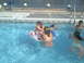 2003 Yamaha RAPTOR 80 - Children enjoy a day at the swimming pool, splashing and playing with inflatable rings.