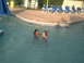 2003 Yamaha RAPTOR 80 - Children enjoy a day at the pool, with lounge chairs and a water slide visible.