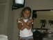 2003 Yamaha RAPTOR 80 - A young girl poses for a photo in a room with a television mounted on the wall.