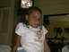 2003 Yamaha RAPTOR 80 - A young girl with braided hair looks towards the camera while sitting indoors.