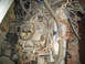 1978 Ford Bronco - Close-up of an engine assembly, showing a carburetor and numerous wires. A chain is wrapped around parts of the engine.