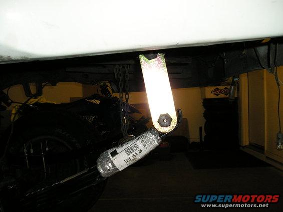close-up of a suspension component with a part number label