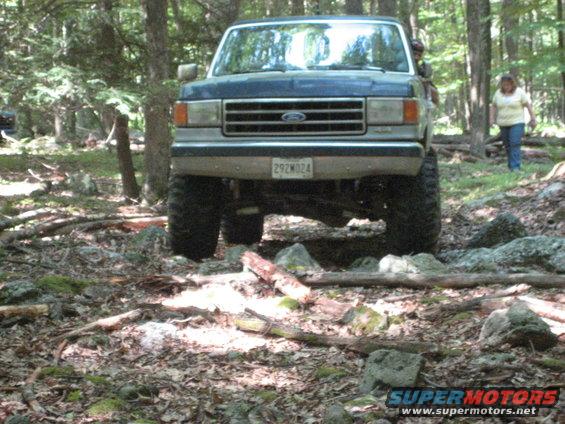 1991 Ford Bronco front view, blue, off-roading on rocky terrain