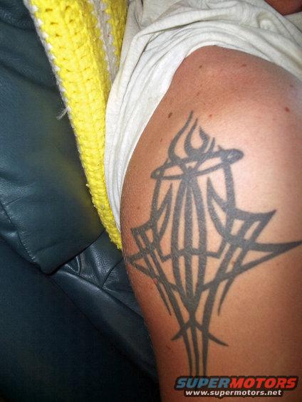Tattoo on arm with tribal design