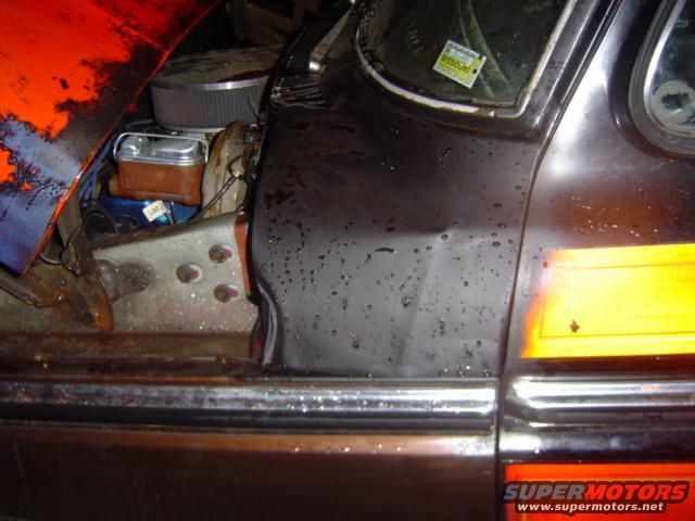 1979 Ford Bronco engine bay with orange and black paint, showing brake fluid reservoir and air filter