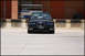 1998 BMW 3 Series - A black BMW 3 Series sedan is parked in front of a loading dock with a brick building in the background.