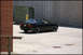 1998 BMW 3 Series - A black 1998 BMW 3 Series coupe is seen from the rear quarter angle, parked on a concrete surface.