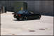 1998 BMW 3 Series - Black BMW E36 coupe parked on concrete with industrial background.