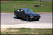 1998 BMW 3 Series - A black BMW 3 Series coupe is shown from a three-quarter front view on a paved road with grass and a sidewalk.