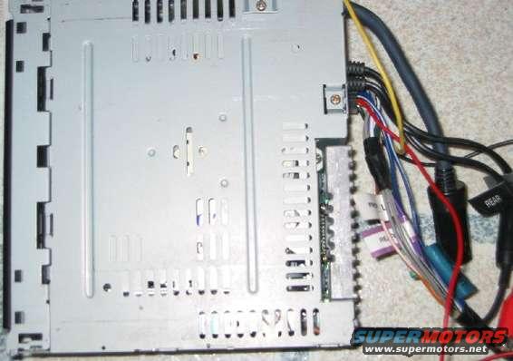 Back of a car stereo with many colorful wires connected