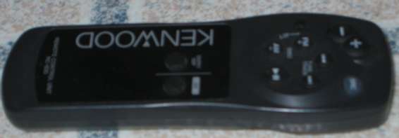 Black Kenwood remote control with a display screen and buttons